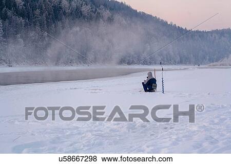 Stock Photo - Man ice-fishing, Ural, Sverdlovsk, Russia. Fotosearch