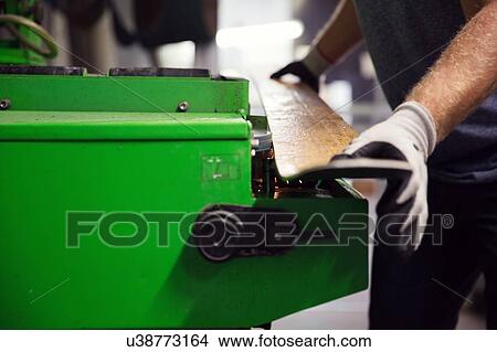 Picture - Man in workshop, making ski equipment, mid section, close-up. Fotosearch