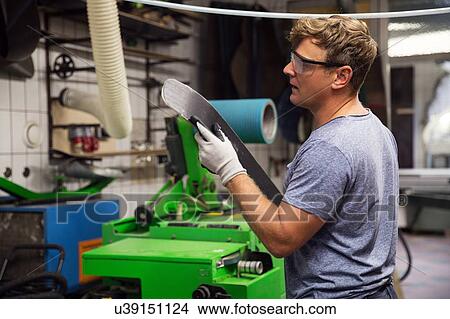 Picture - Man in workshop, making ski equipment. Fotosearch