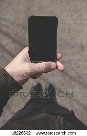 Man looking at smartphone screen on street. View Large Photo Image Stock Image - Man looking at smartphone screen on street.. Fotosearch