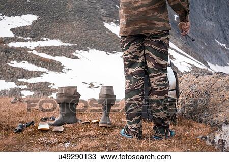 Stock Image - Man on edge of crater, Ural, Sverdlovsk, Russia. Fotosearch