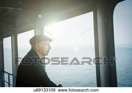 Man on ferry looking away out of window View Large Photo Image Stock Photo - Man on ferry looking away out of window. Fotosearch
