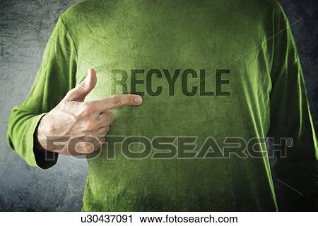 Stock Image - Man pointing to recycle printed on his shirt.. Fotosearch