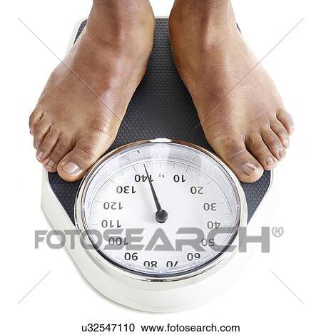 Man standing on weighing scales. View Large Photo Image Stock Image - Man standing on weighing scales.. Fotosearch
