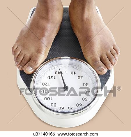 Man standing on weighing scales. View Large Photo Image Stock Photography - Man standing on weighing scales.. Fotosearch