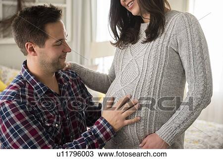 Man touching pregnant partner View Large Photo Image Stock Image - Man touching pregnant partner. Fotosearch