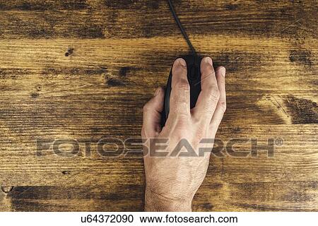 Stock Image - Man using computer mouse, top view.. Fotosearch