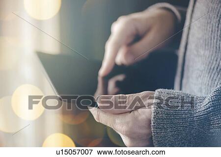 Stock Photo - Man using digital tablet computer.. Fotosearch