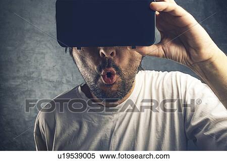 Stock Photography - Man watching 3d virtual content, conceptual image.. Fotosearch