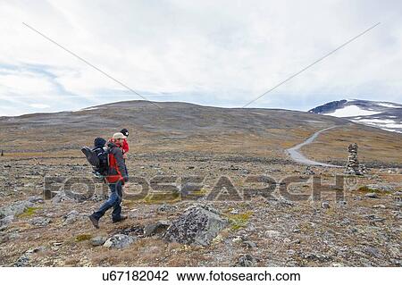 Man with sons hiking in mountain landscape, Jotunheimen National Park, Lom, Oppland, Norway View Large Photo Image Stock Image - Man with sons hiking in mountain landscape, Jotunheimen National Park, Lom, Oppland, Norway. Fotosearch