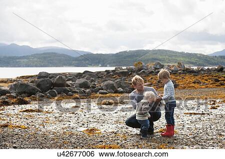 Man with sons looking at nature by fjord, Aure, More og Romsdal, Norway View Large Photo Image Stock Photograph - Man with sons looking at nature by fjord, Aure, More og Romsdal, Norway. Fotosearch