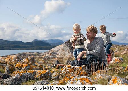Man with sons playing by fjord, Aure, More og Romsdal, Norway View Large Photo Image Stock Image - Man with sons playing by fjord, Aure, More og Romsdal, Norway. Fotosearch