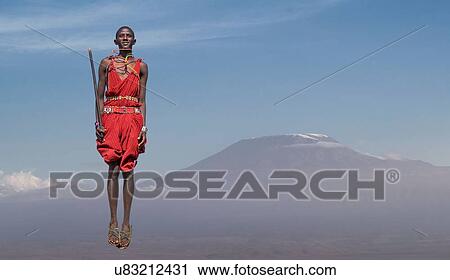 Masai man with traditional dress jumping in front of Mount Kilimanjaro, Amboseli, Rift Valley, Kenya View Large Photo Image Stock Image - Masai man with traditional dress jumping in front of Mount Kilimanjaro, Amboseli, Rift Valley, Kenya. Fotosearch
