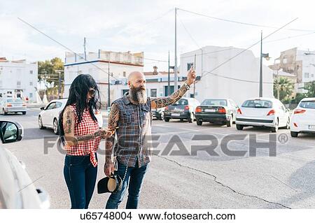 Mature hipster couple hailing a cab, Valencia, Spain View Large Photo Image Picture - Mature hipster couple hailing a cab, Valencia, Spain. Fotosearch