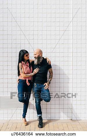 Mature hipster couple leaning against white wall View Large Photo Image Picture - Mature hipster couple leaning against white wall. Fotosearch