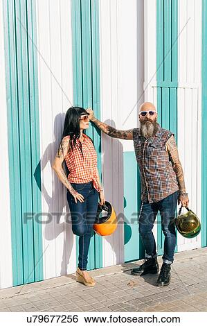 Mature hipster couple leaning against striped wall, portrait View Large Photo Image Stock Photograph - Mature hipster couple leaning against striped wall, portrait. Fotosearch