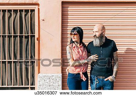 Mature hipster couple looking away from sidewalk View Large Photo Image Stock Photo - Mature hipster couple looking away from sidewalk. Fotosearch