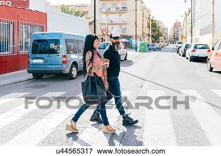 Stock Photo - Mature hipster couple on pedestrian crossing. Fotosearch