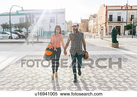 Stock Photography - Mature hipster couple strolling hand in hand, Valencia, Spain. Fotosearch