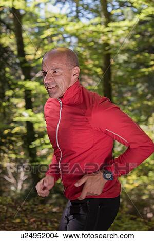 Mature male runner running in woodland View Large Photo Image Picture - Mature male runner running in woodland. Fotosearch