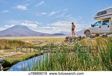 Mature man standing on rock, beside recreational vehicle, looking at view, Salar de Chiguana, Chiguana, Potosi, Bolivia, South America View Large Photo Image Stock Photo - Mature man standing on rock, beside recreational vehicle, looking at view, Salar de Chiguana, Chiguana, Potosi, Bolivia, South America. Fotosearch