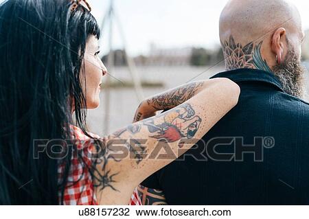 Mature tattooed hipster woman leaning on boyfriends shoulder View Large Photo Image Stock Image - Mature tattooed hipster woman leaning on boyfriends shoulder. Fotosearch