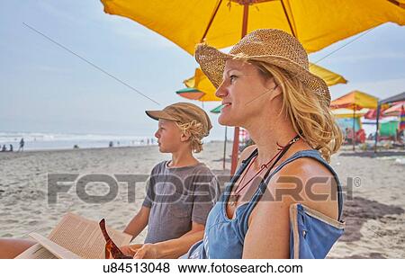 Stock Photo - Mature woman and son relaxing on beach, Camana, Arequipa, Peru. Fotosearch