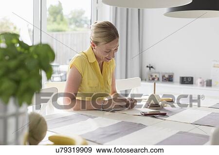 Mature woman making macrame at table View Large Photo Image Stock Photo - Mature woman making macrame at table. Fotosearch