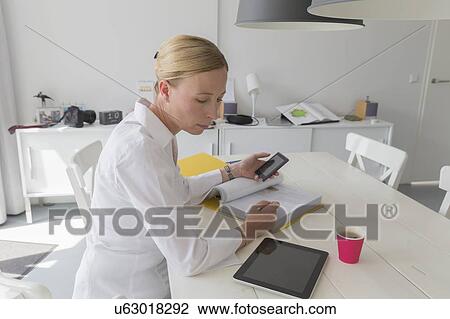 Mature woman working at table View Large Photo Image Stock Image - Mature woman working at table. Fotosearch