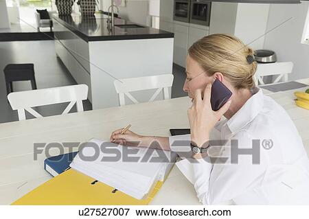 Stock Photo - Mature woman working at table. Fotosearch