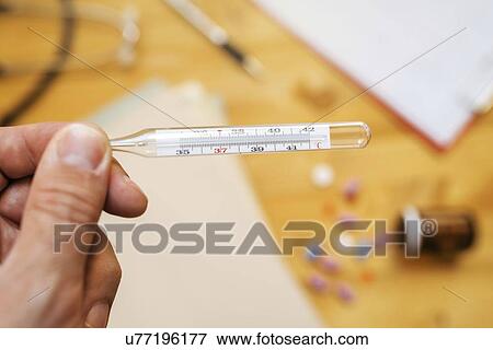 Stock Photo - Measuring body temperature.. Fotosearch