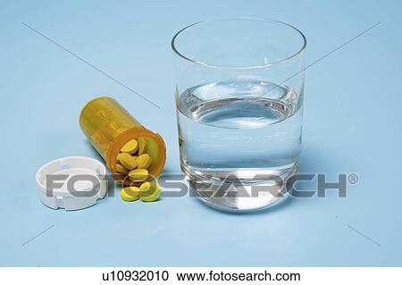 Medication and glass of water on a blue background. View Large Photo Image Stock Image - Medication and glass of water on a blue background.. Fotosearch