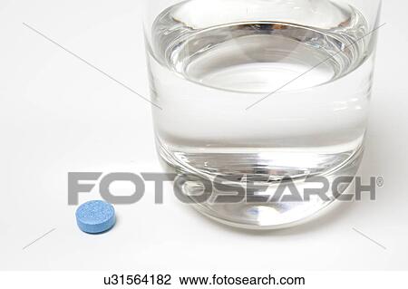 Medication and glass of water on a white background. View Large Photo Image Stock Image - Medication and glass of water on a white background.. Fotosearch