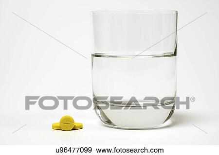 Medication and glass of water on a white background. View Large Photo Image Stock Photo - Medication and glass of water on a white background.. Fotosearch