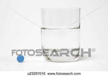 Medication and glass of water on a white background. View Large Photo Image Stock Photograph - Medication and glass of water on a white background.. Fotosearch