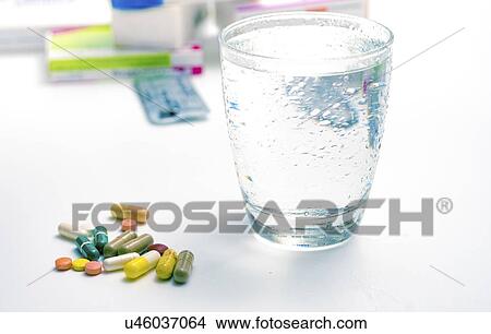 Picture - Medicines and glass of water.. Fotosearch