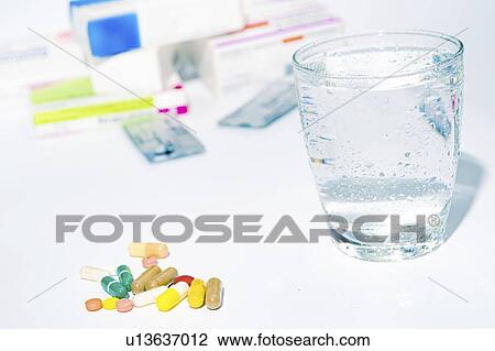 Medicines and glass of water. View Large Photo Image Stock Image - Medicines and glass of water.. Fotosearch