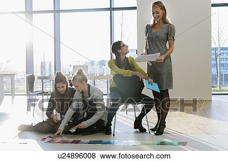 Mentor and colleagues working with colour swatches View Large Photo Image Stock Photo - Mentor and colleagues working with colour swatches. Fotosearch
