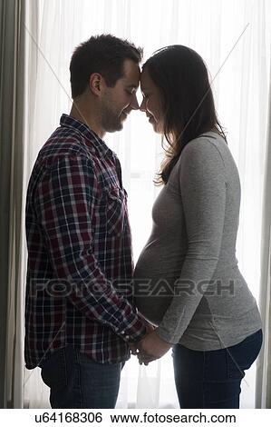 Mid adult couple in front of window, face to face View Large Photo Image Stock Photograph - Mid adult couple in front of window, face to face. Fotosearch