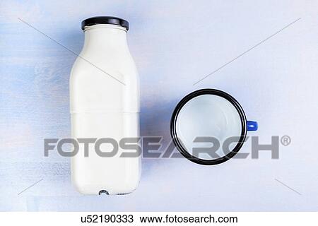 Milk bottle and metal cup, top view. View Large Photo Image Stock Image - Milk bottle and metal cup, top view.. Fotosearch