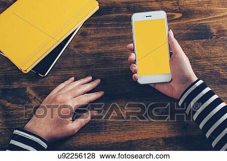 Mock up of female hands using smartphone, top view. View Large Photo Image Stock Photo - Mock up of female hands using smartphone, top view.. Fotosearch