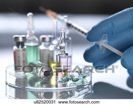 Stock Image - MODEL RELEASED. Pharmaceutical research. A variety of potential new drugs in a petri dish.. Fotosearch