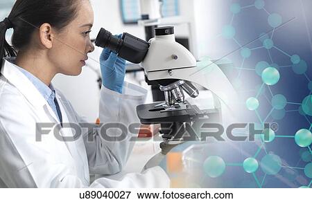 MODEL RELEASED. Scientist viewing a sample down a light microscope with a molecular model to illustrate research. View Large Photo Image Stock Photo - MODEL RELEASED. Scientist viewing a sample down a light microscope with a molecular model to illustrate research.. Fotosearch
