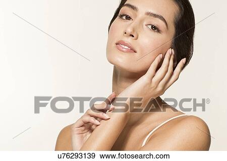 MODEL RELEASED. Young woman touching face, portrait. View Large Photo Image Stock Photo - MODEL RELEASED. Young woman touching face, portrait.. Fotosearch