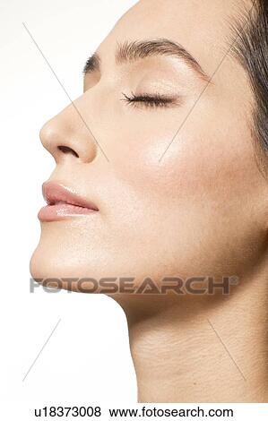 Stock Photo - MODEL RELEASED. Young woman with eyes closed, close up portrait.. Fotosearch