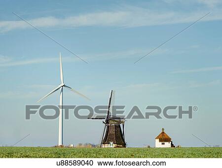 Modern wind turbine and traditional Dutch windmill stand together, Workum, Friesland, Netherlands View Large Photo Image Stock Image - Modern wind turbine and traditional Dutch windmill stand together, Workum, Friesland, Netherlands. Fotosearch