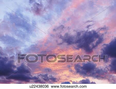 Moody and dramatic colorful sky at sunset View Large Photo Image Stock Photograph - Moody and dramatic colorful sky at sunset. Fotosearch