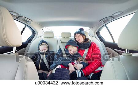 Mother and children sleeping in car View Large Photo Image Stock Image - Mother and children sleeping in car. Fotosearch