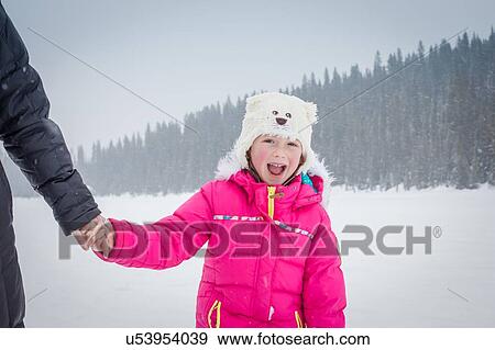 Stock Photo - Mother and daughter on frozen Lake Louise, Canada. Fotosearch