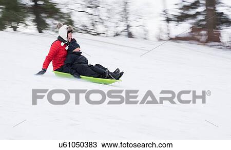 Mother and son sledding on snowy hill View Large Photo Image Stock Image - Mother and son sledding on snowy hill. Fotosearch